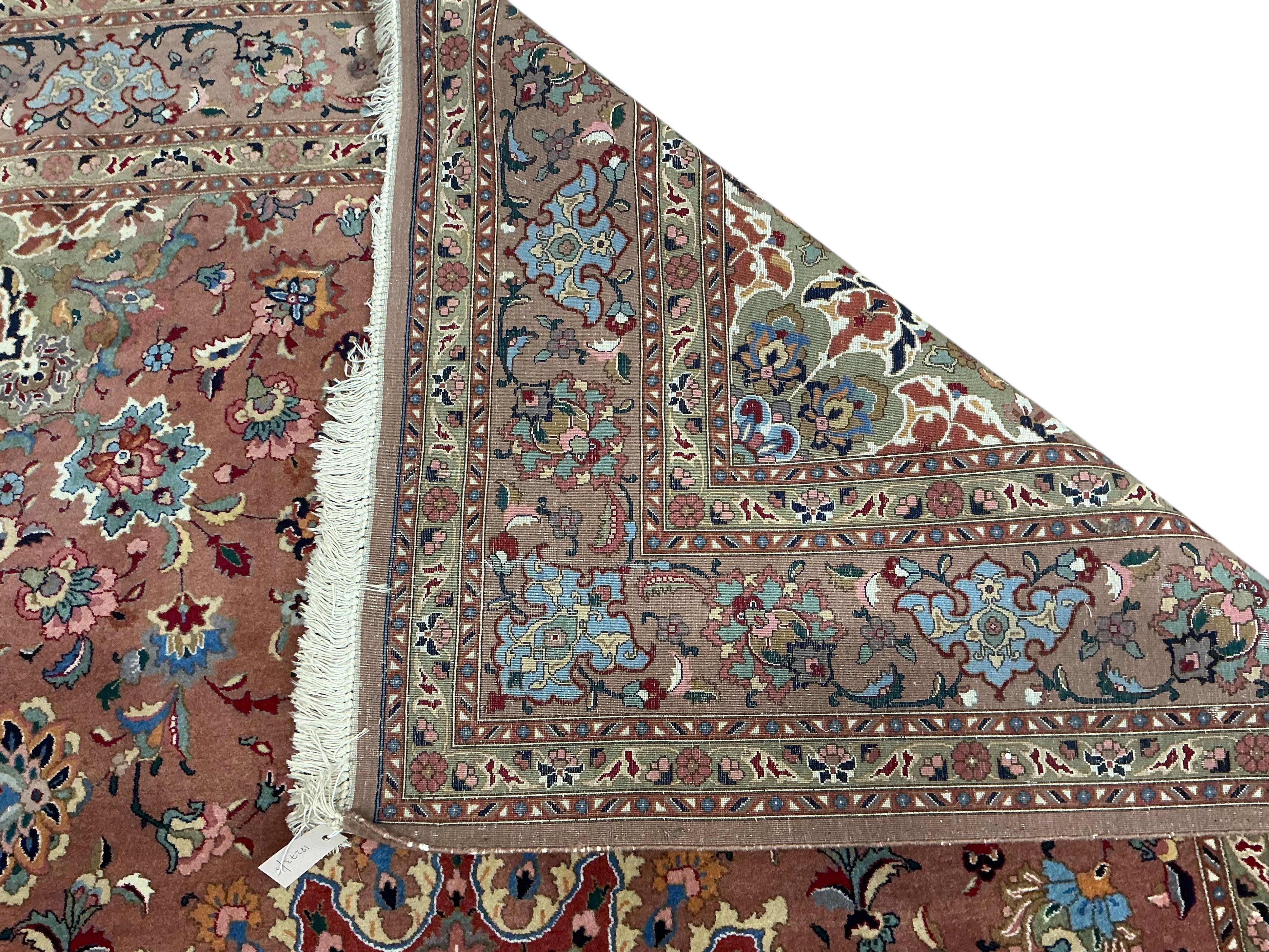A Tabriz peach ground carpet, 292 x 205cm